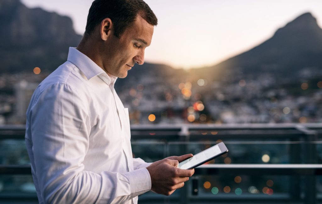 Business man looking at iPad.
