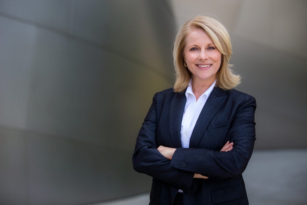 Smiling appraiser in dark suit. 